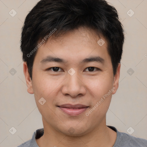 Joyful asian young-adult male with short  black hair and brown eyes