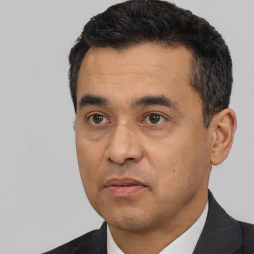 Neutral latino adult male with short  black hair and brown eyes