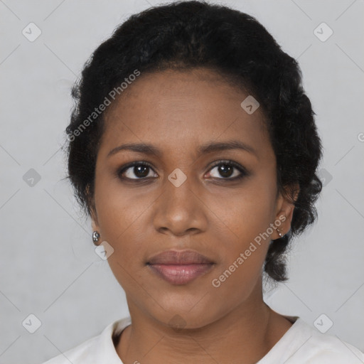 Joyful black young-adult female with short  black hair and brown eyes