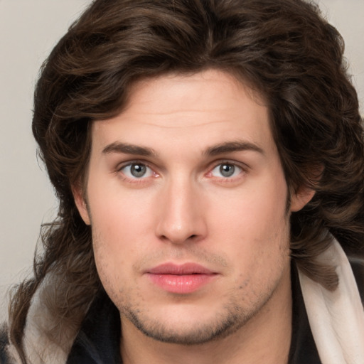 Neutral white young-adult male with long  brown hair and brown eyes