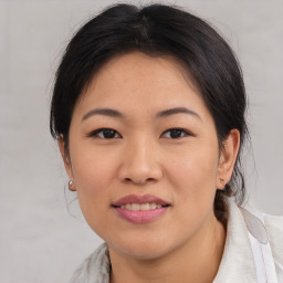 Joyful asian young-adult female with medium  brown hair and brown eyes