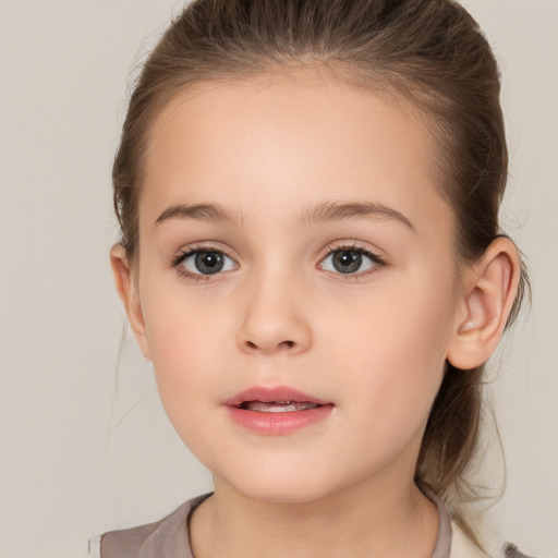 Joyful white child female with medium  brown hair and brown eyes