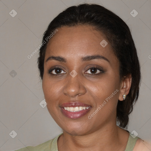 Joyful black young-adult female with medium  black hair and brown eyes