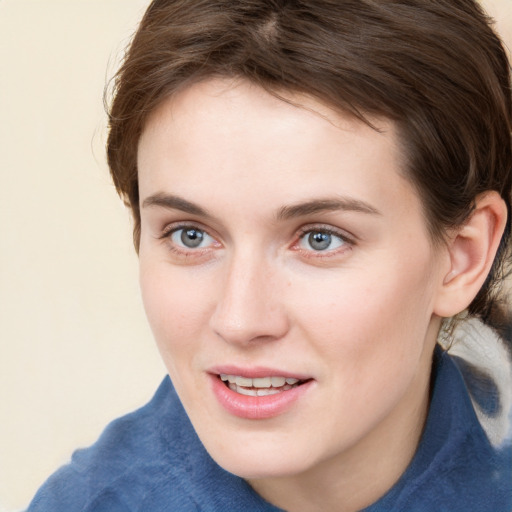 Joyful white young-adult female with medium  brown hair and blue eyes