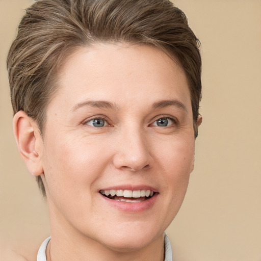 Joyful white young-adult female with short  brown hair and grey eyes