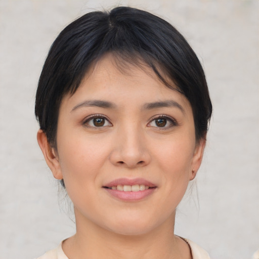 Joyful asian young-adult female with short  brown hair and brown eyes