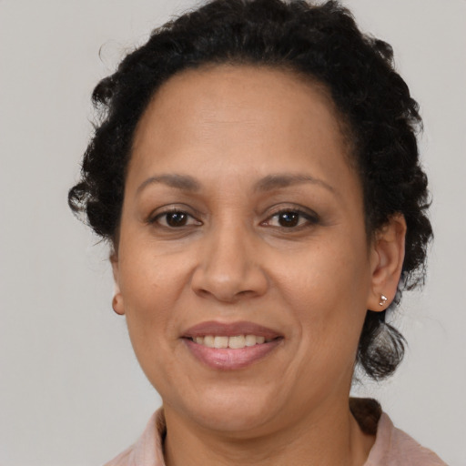 Joyful black adult female with medium  brown hair and brown eyes