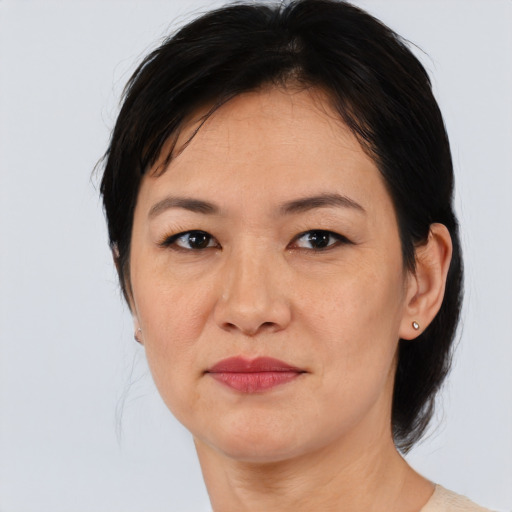 Joyful asian adult female with medium  black hair and brown eyes