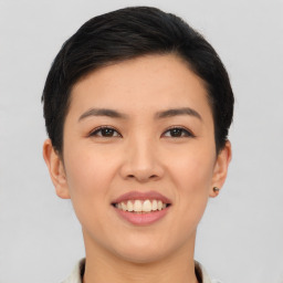 Joyful asian young-adult female with short  black hair and brown eyes