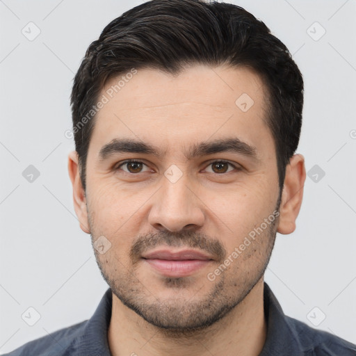 Joyful white young-adult male with short  black hair and brown eyes