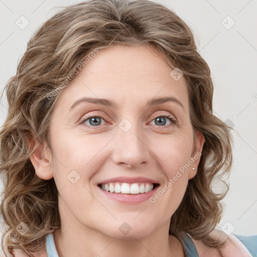 Joyful white young-adult female with medium  brown hair and blue eyes