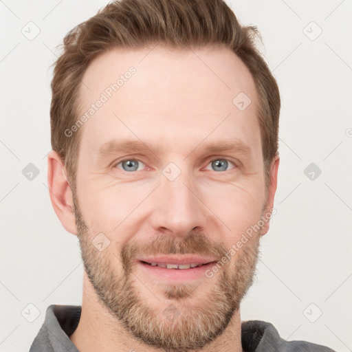 Joyful white adult male with short  brown hair and grey eyes