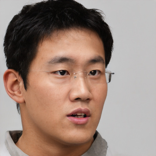 Neutral asian young-adult male with short  brown hair and brown eyes