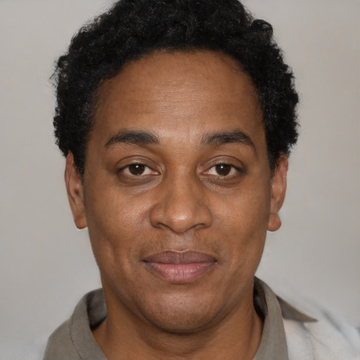 Joyful latino adult male with short  black hair and brown eyes