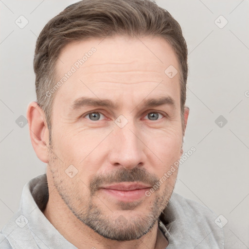 Joyful white adult male with short  brown hair and grey eyes