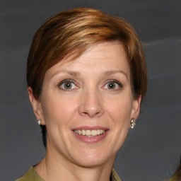 Joyful white adult female with short  brown hair and grey eyes