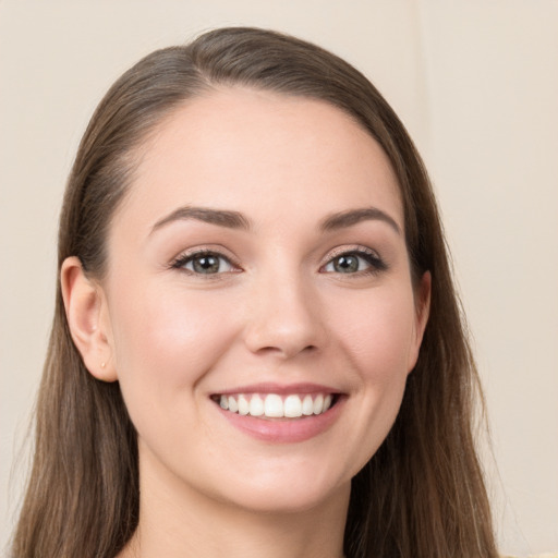 Joyful white young-adult female with long  brown hair and grey eyes