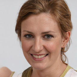 Joyful white adult female with medium  brown hair and brown eyes