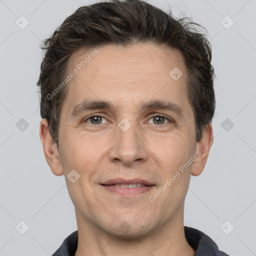 Joyful white adult male with short  brown hair and brown eyes