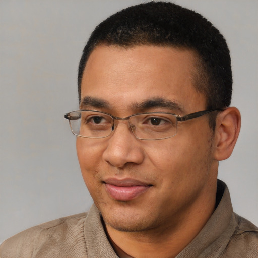 Joyful white adult male with short  black hair and brown eyes