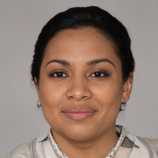 Joyful black young-adult female with short  black hair and brown eyes