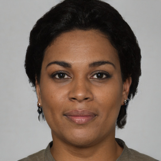 Joyful black young-adult female with short  black hair and brown eyes