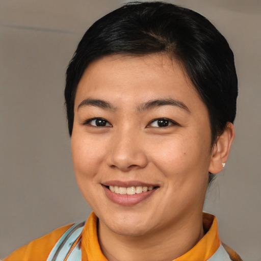 Joyful asian young-adult female with short  brown hair and brown eyes