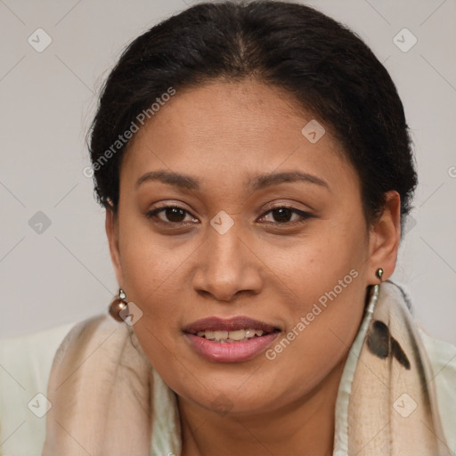 Joyful latino adult female with long  brown hair and brown eyes