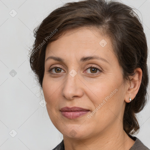 Joyful white adult female with medium  brown hair and brown eyes