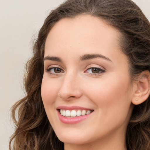 Joyful white young-adult female with long  brown hair and green eyes