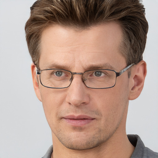 Joyful white adult male with short  brown hair and grey eyes