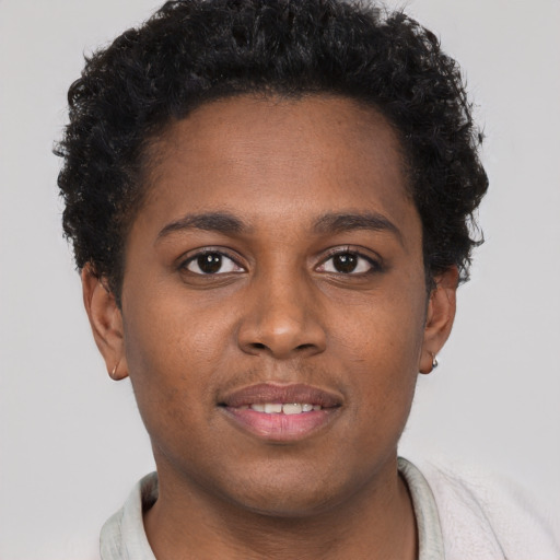 Joyful black young-adult female with short  brown hair and brown eyes