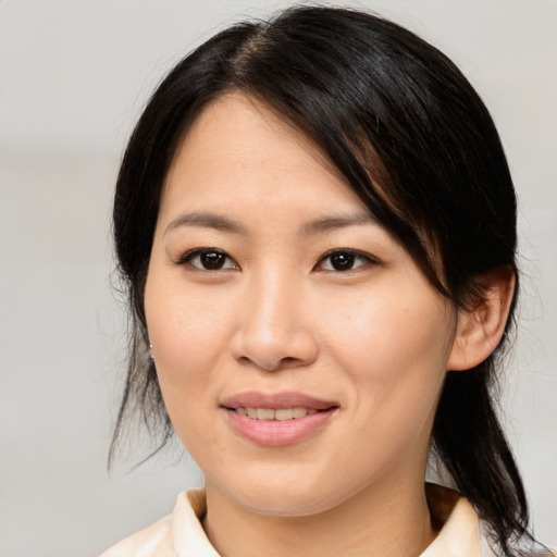 Joyful asian young-adult female with medium  brown hair and brown eyes