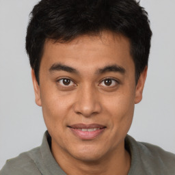 Joyful asian young-adult male with short  brown hair and brown eyes