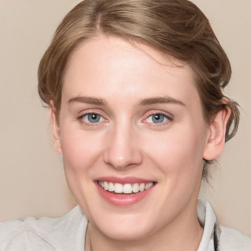 Joyful white young-adult female with medium  brown hair and blue eyes