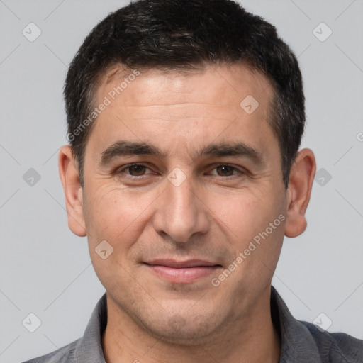 Joyful white adult male with short  brown hair and brown eyes