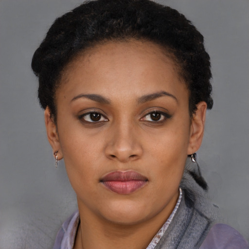 Joyful black young-adult female with short  brown hair and brown eyes