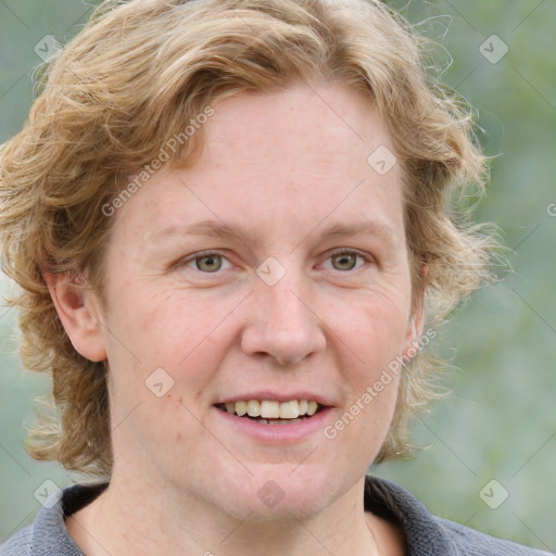 Joyful white adult female with medium  brown hair and blue eyes