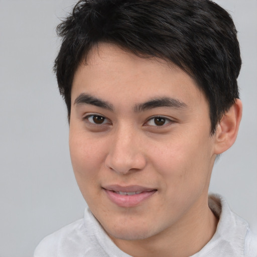 Joyful asian young-adult male with short  brown hair and brown eyes