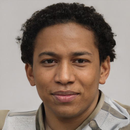 Joyful black young-adult male with short  brown hair and brown eyes