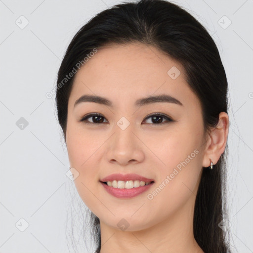 Joyful asian young-adult female with long  brown hair and brown eyes