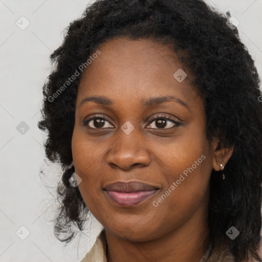 Joyful black young-adult female with long  brown hair and brown eyes