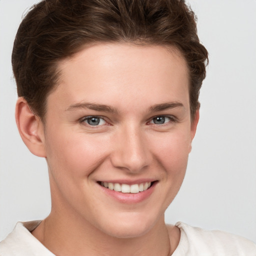 Joyful white young-adult female with short  brown hair and grey eyes