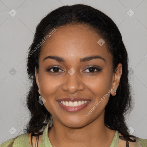 Joyful black young-adult female with long  black hair and brown eyes