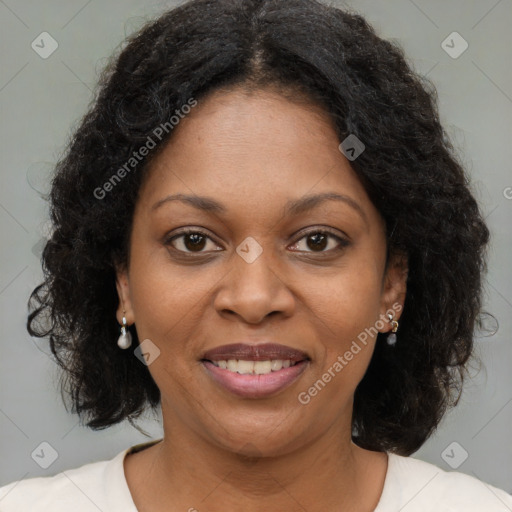 Joyful black adult female with medium  brown hair and brown eyes