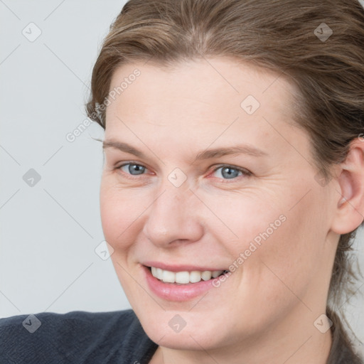 Joyful white young-adult female with medium  brown hair and blue eyes