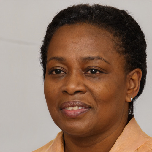 Joyful black adult female with short  brown hair and brown eyes