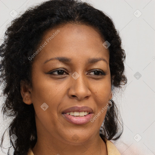 Joyful black adult female with long  brown hair and brown eyes