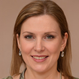 Joyful white adult female with long  brown hair and brown eyes