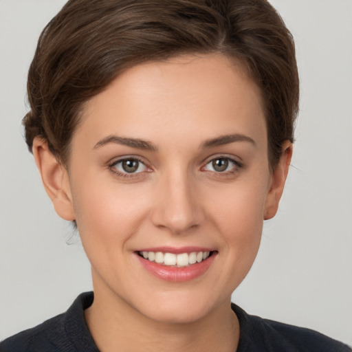 Joyful white young-adult female with short  brown hair and brown eyes